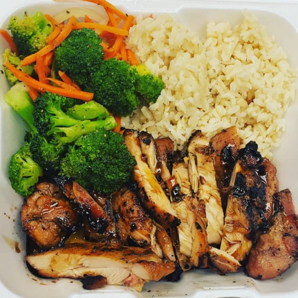 Hungry Hawaiian's teriyaki chicken plate with brown rice, broccoli, and carrots in a white takeout container.