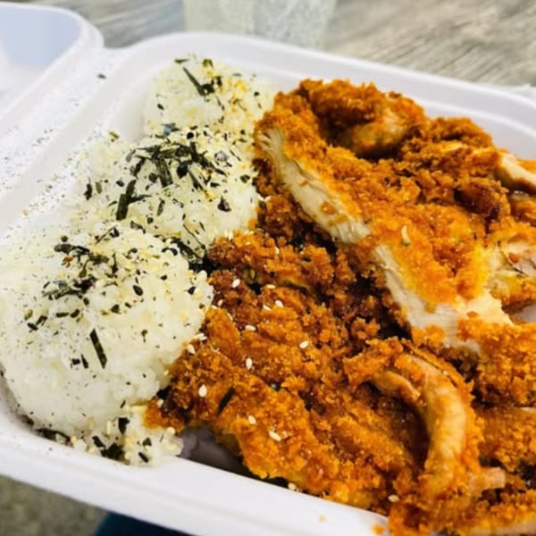 Crispy fried chicken katsu with white rice and furikake in a takeout container from Hungry Hawaiian.