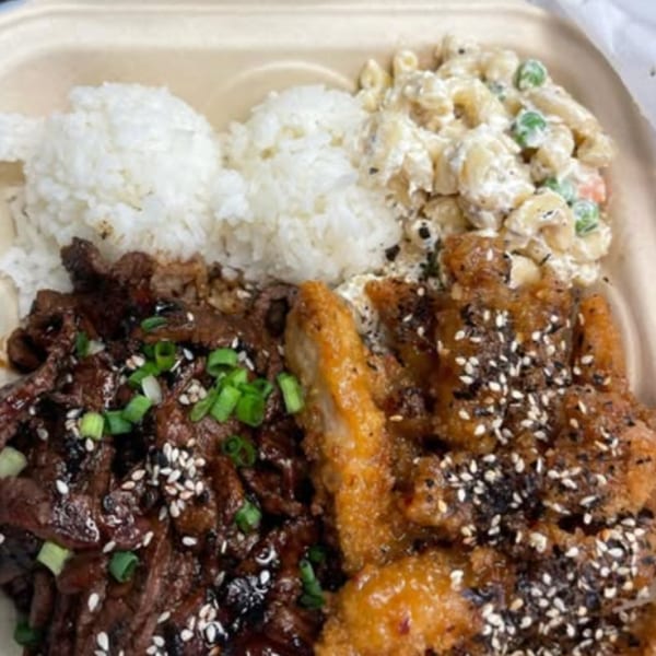 A Hungry Hawaiian plate lunch with teriyaki beef, crispy chicken, rice, and macaroni salad.